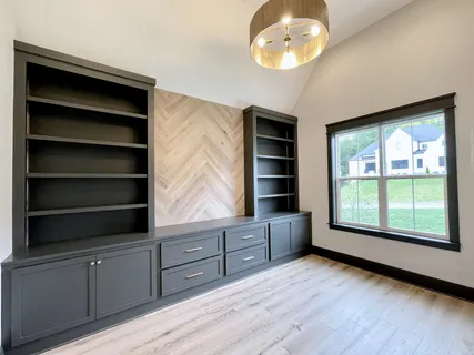 a kitchen with a sink cabinets and window