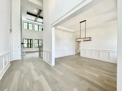 a view of a hallway with closet and chandelier