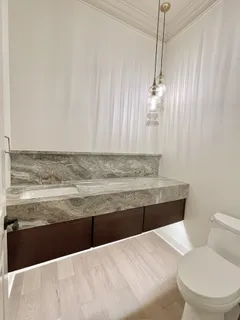 a view of a livingroom with wooden floor and a fireplace