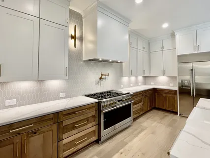 a bathroom with a granite countertop sink a toilet a mirror and shower