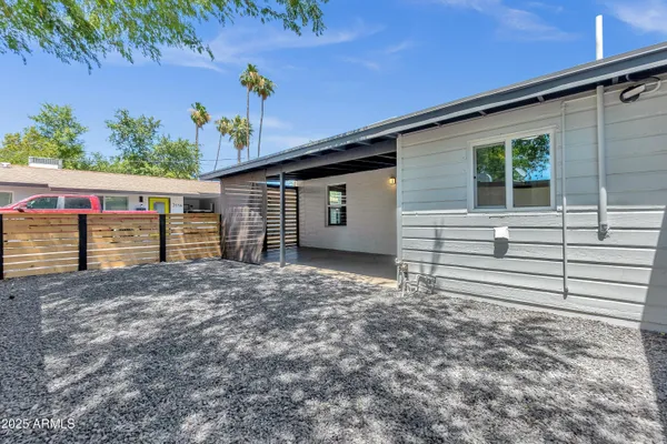 a view of a house with a backyard