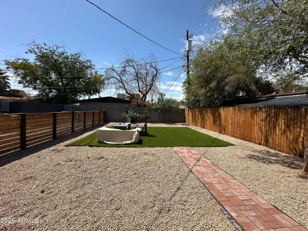 a view of a backyard with wooden fence