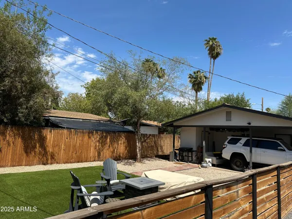 a view of a house with backyard water fountain and sitting area