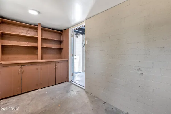 a view of walk in closet with empty racks