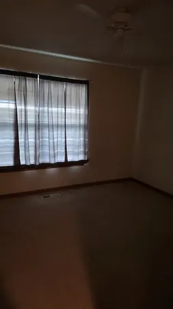 a view of a hallway with wooden shelves