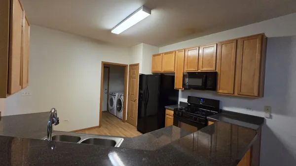 a kitchen with stainless steel appliances granite countertop a refrigerator stove and microwave