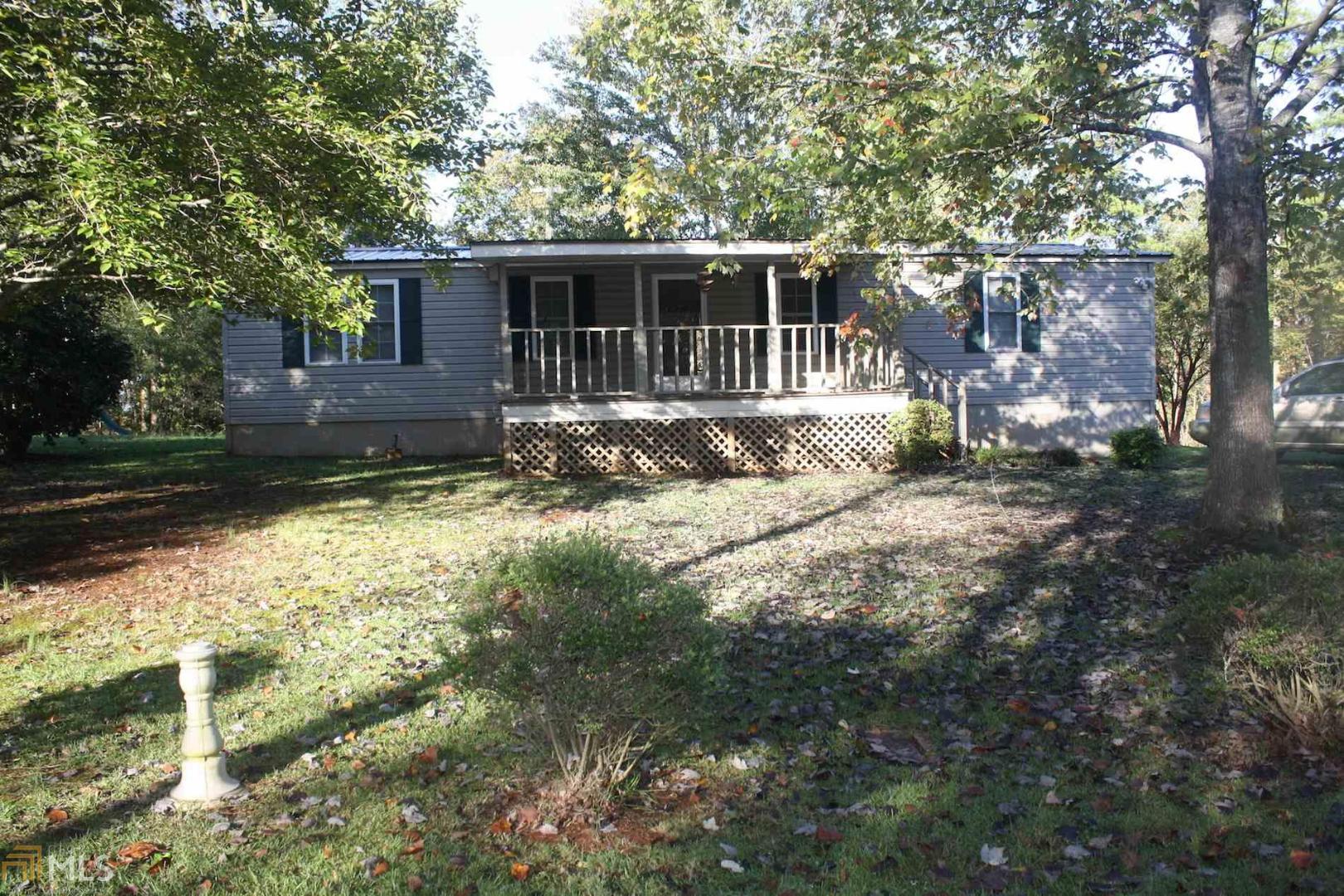 a view of house with backyard space and garden