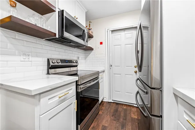 a close view of a refrigerator in kitchen and stainless steel appliances
