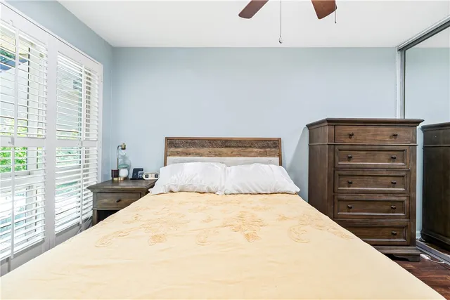 a bedroom with a large bed and a large window