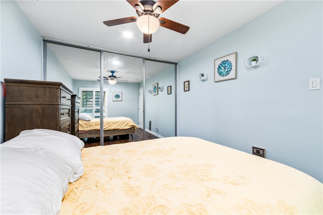 7890 East Spring Street Long Beach, CA 90815 - Photo 37 of 59 a bedroom with a bed and a chandelier