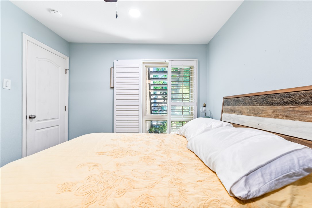 7890 East Spring Street Long Beach, CA 90815 - Photo 38 of 59 a bedroom with a large bed and a large window