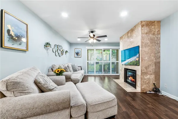 a bed sitting in a spacious bedroom next to a window and a fireplace