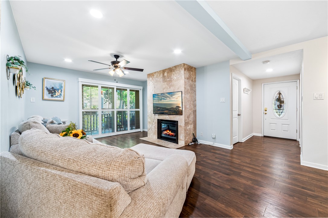 7890 East Spring Street Long Beach, CA 90815 - Photo 7 of 59 a bed sitting in a spacious bedroom next to a window and a fireplace