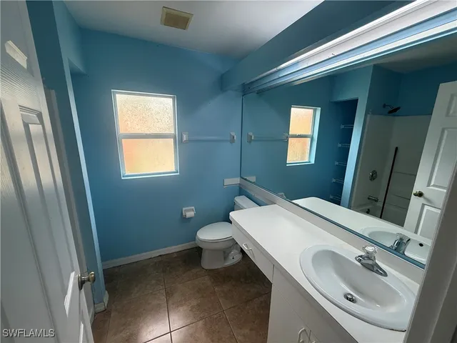 a bathroom with a sink toilet and mirror