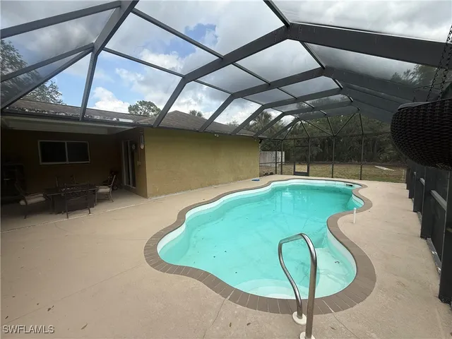 a view of a swimming pool with a yard