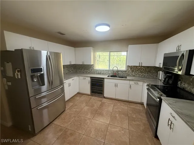 a kitchen with a refrigerator sink and microwave