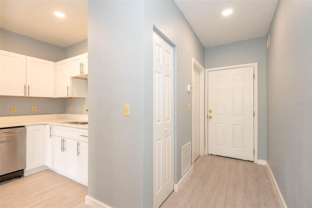 946 15th Street, Unit 202 Daytona Beach, FL 32117 - Photo 16 of 40 a view of a kitchen with white cabinets and a refrigerator