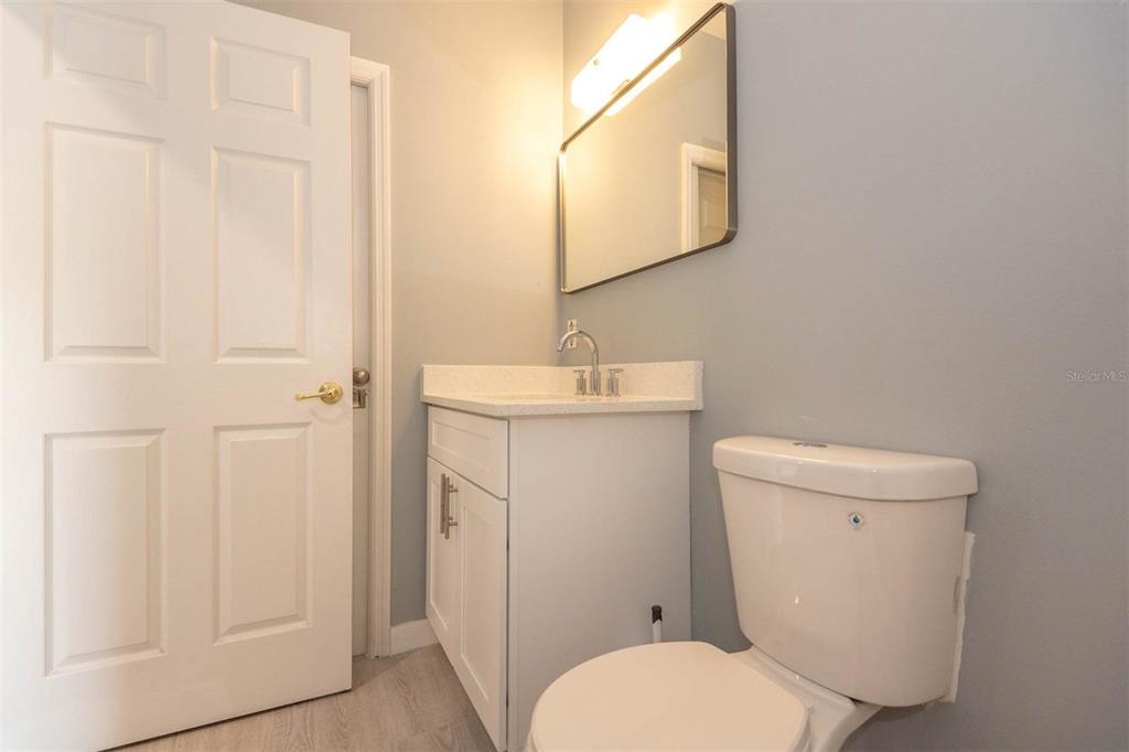 946 15th Street, Unit 202 Daytona Beach, FL 32117 - Photo 24 of 40 a white toilet sitting next to a bathroom sink