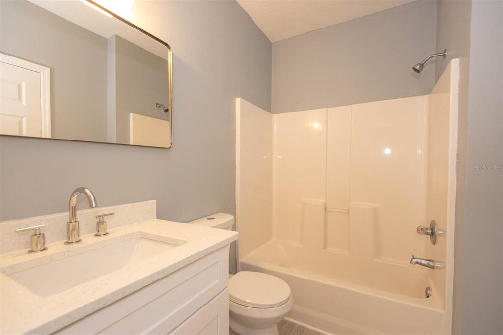 946 15th Street, Unit 202 Daytona Beach, FL 32117 - Photo 25 of 40 a bathroom with a sink a toilet and shower