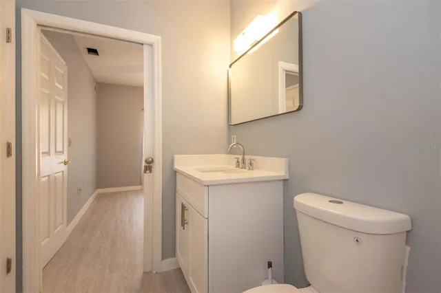 a bathroom with a sink toilet and mirror
