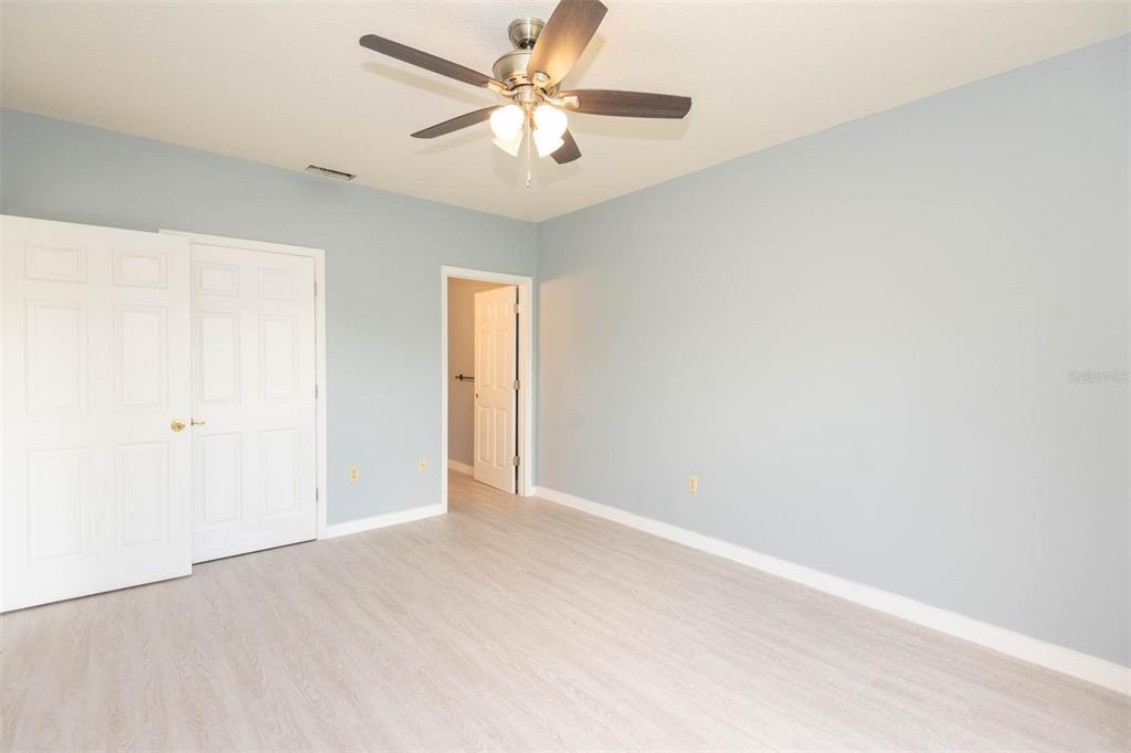 946 15th Street, Unit 202 Daytona Beach, FL 32117 - Photo 31 of 40 an empty room with a chandelier fan and windows