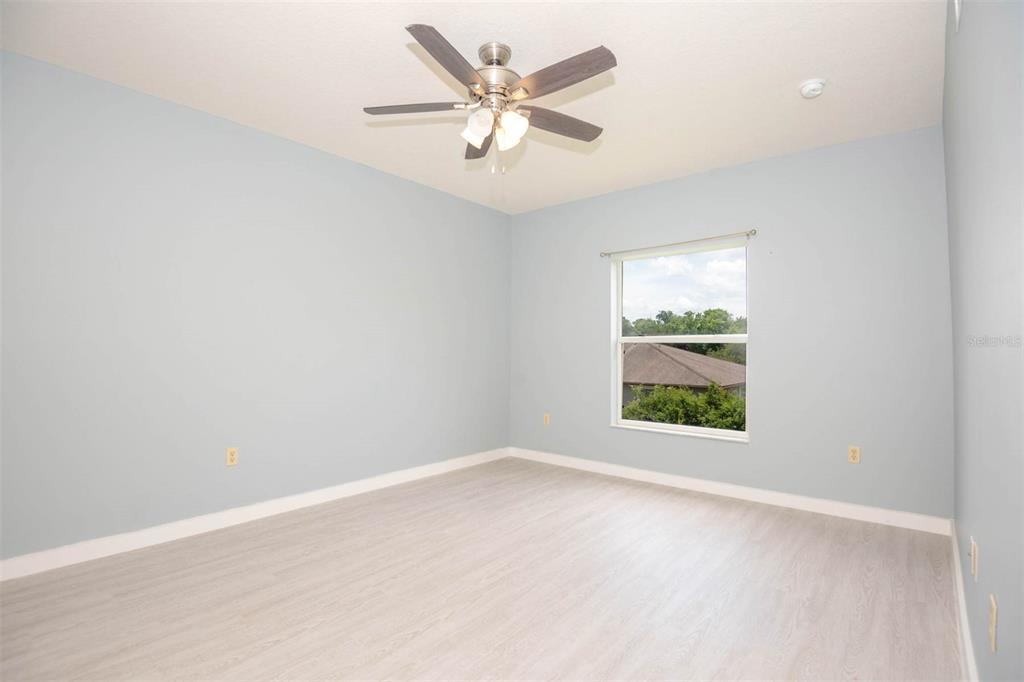 946 15th Street, Unit 202 Daytona Beach, FL 32117 - Photo 35 of 40 an empty room with windows and ceiling fan