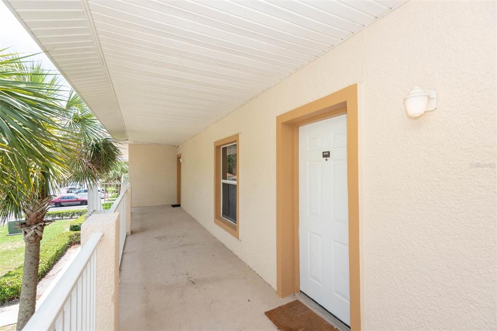 946 15th Street, Unit 202 Daytona Beach, FL 32117 - Photo 9 of 40 a view of a hallway with wooden walls