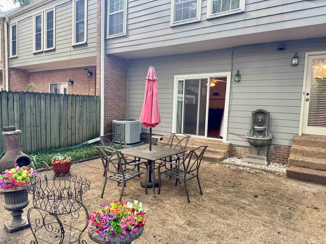 a view of a patio with table and chairs and potted plants