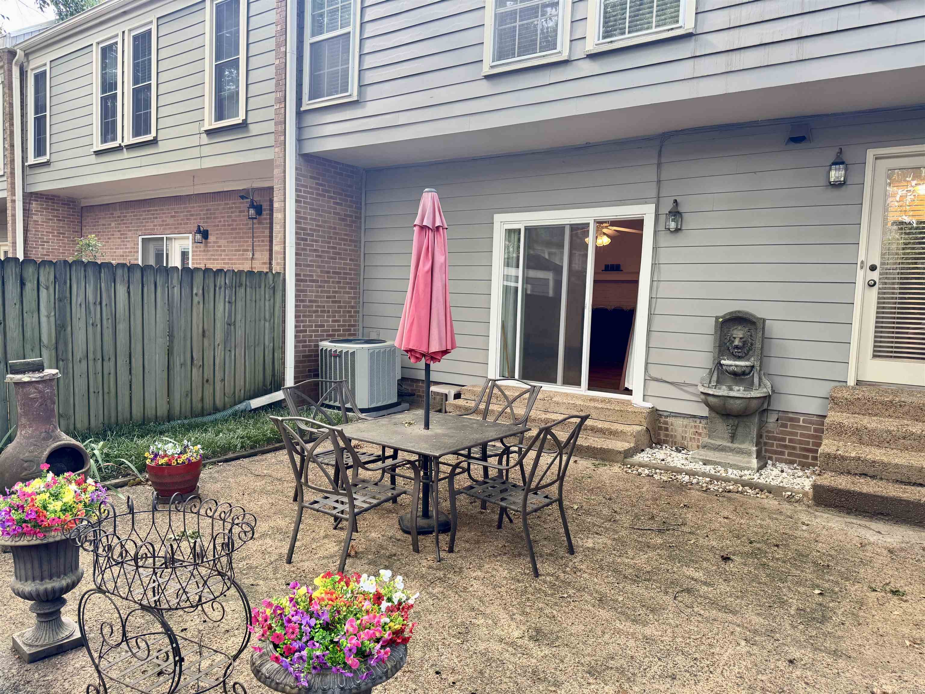 a view of a patio with table and chairs and potted plants