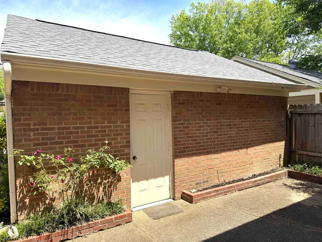 a view of a room with furniture and window
