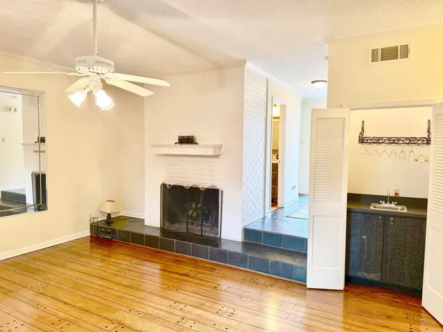 a view of a livingroom with a fireplace and window