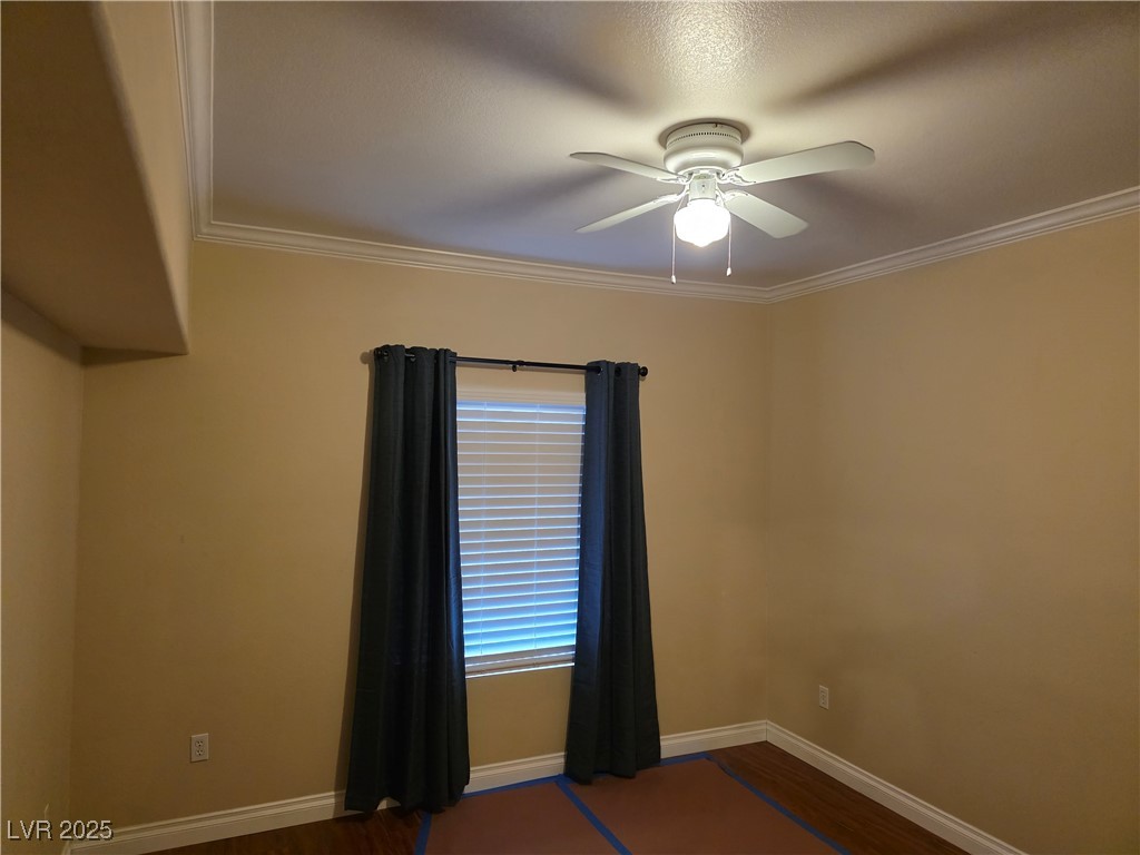 7255 West Sunset Road, Unit 1171 Las Vegas, NV 89113 - Photo 8 of 12 Spare room featuring baseboards, ceiling fan, and crown molding