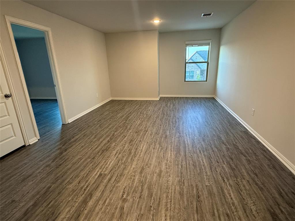 615 Metallic Tree Lane Van Alstyne, TX 75495 - Photo 13 of 24 an empty room with wooden floor and windows