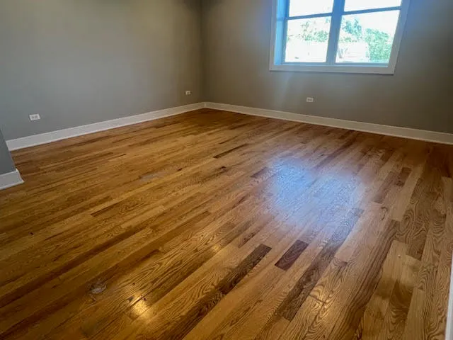 a view of a room with wooden floor and windows