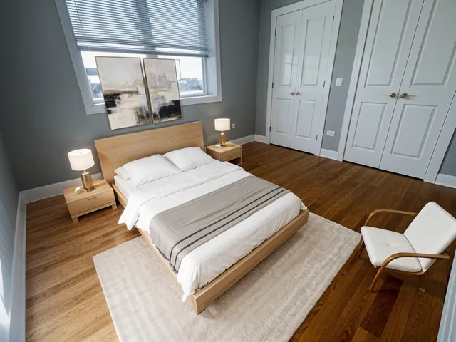 a bedroom with a bed wooden floor and window