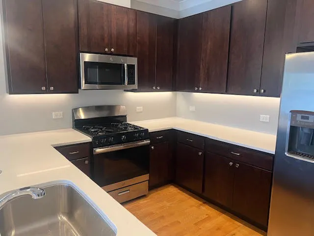 a kitchen with a sink and a stove top oven