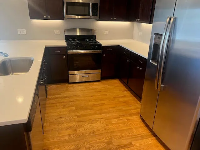 a kitchen with stainless steel appliances a refrigerator and a sink
