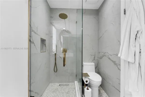 a bathroom with a toilet and shower