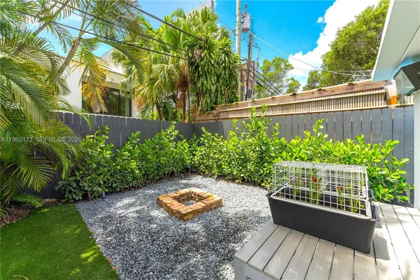 a view of a garden with sitting area