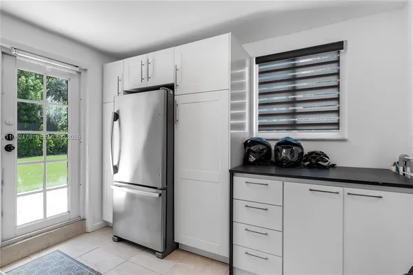 a kitchen with a refrigerator and a sink