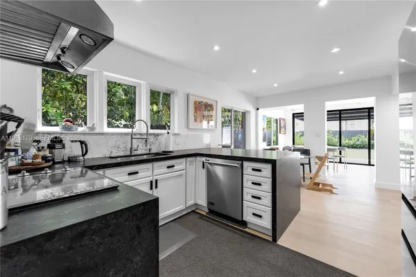 a kitchen with stainless steel appliances granite countertop a stove and a sink