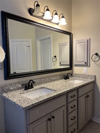a white toilet sitting next to a wooden cabinet