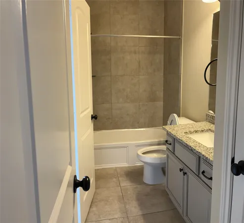 an empty room with a chandelier fan and windows