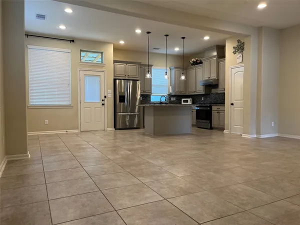 a kitchen with stainless steel appliances a refrigerator sink and cabinets