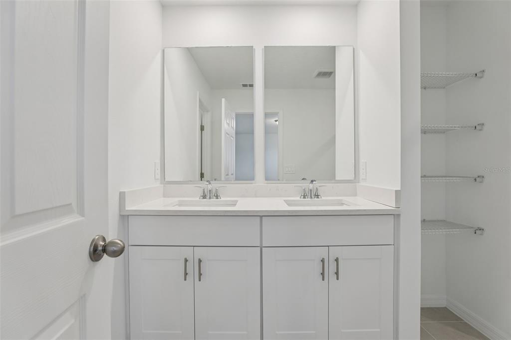 4264 Ranch House Road St. Cloud, FL 34772 - Photo 44 of 74 a bathroom with a sink and a mirror
