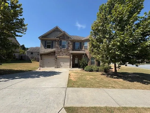 a front view of a house with a yard
