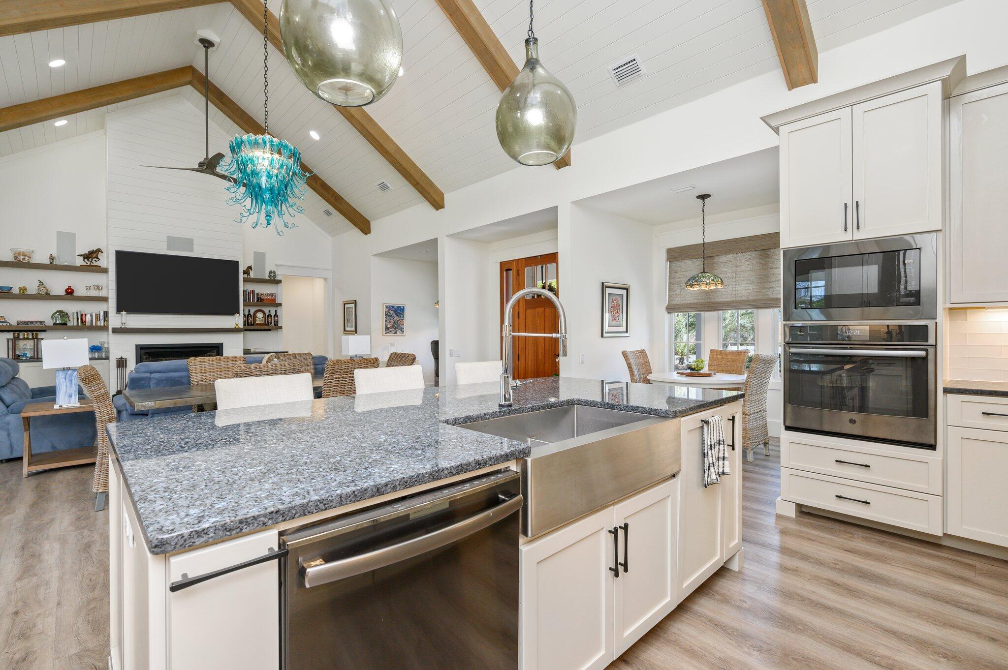 30 Fox Lake Drive Santa Rosa Beach, FL 32459 - Photo 15 of 90 a kitchen with stainless steel appliances granite countertop a stove top oven a sink dishwasher a dining table and chairs with wooden floor