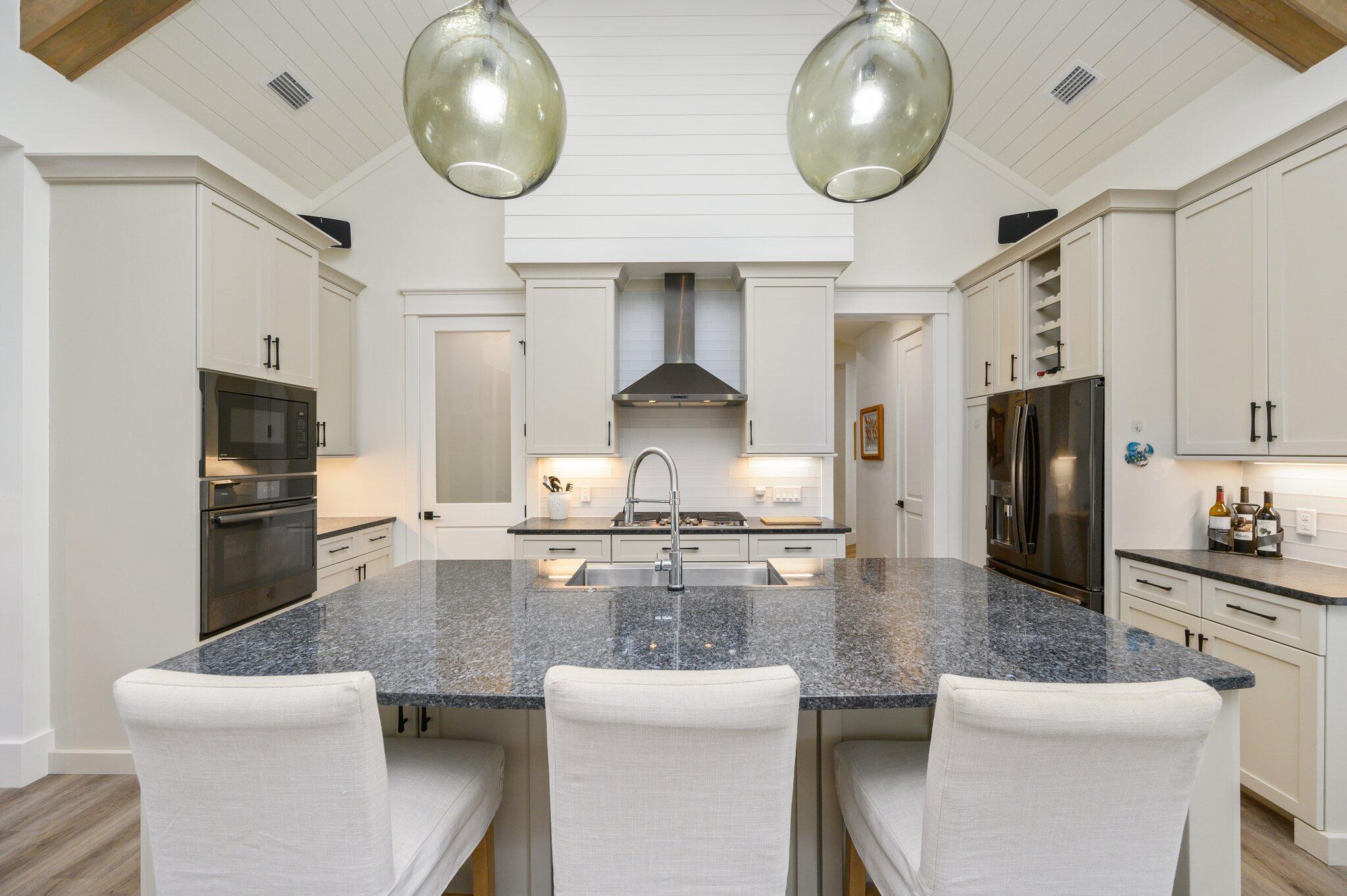 30 Fox Lake Drive Santa Rosa Beach, FL 32459 - Photo 17 of 90 a kitchen with stainless steel appliances granite countertop a stove a sink a dining table and chairs with wooden floor