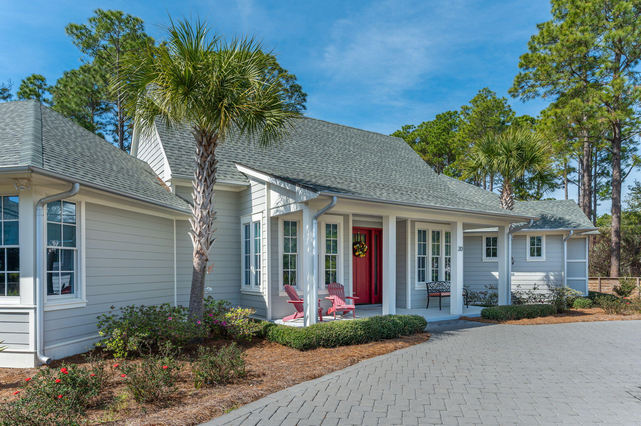 30 Fox Lake Drive Santa Rosa Beach, FL 32459 - Photo 70 of 90 a view of a white house with a large tree and flower plants