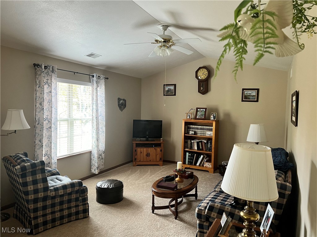 15372B Sprucevale Road East Liverpool, OH 43920 - Photo 7 of 14 Living room featuring ceiling fan, carpet flooring, and vaulted ceiling